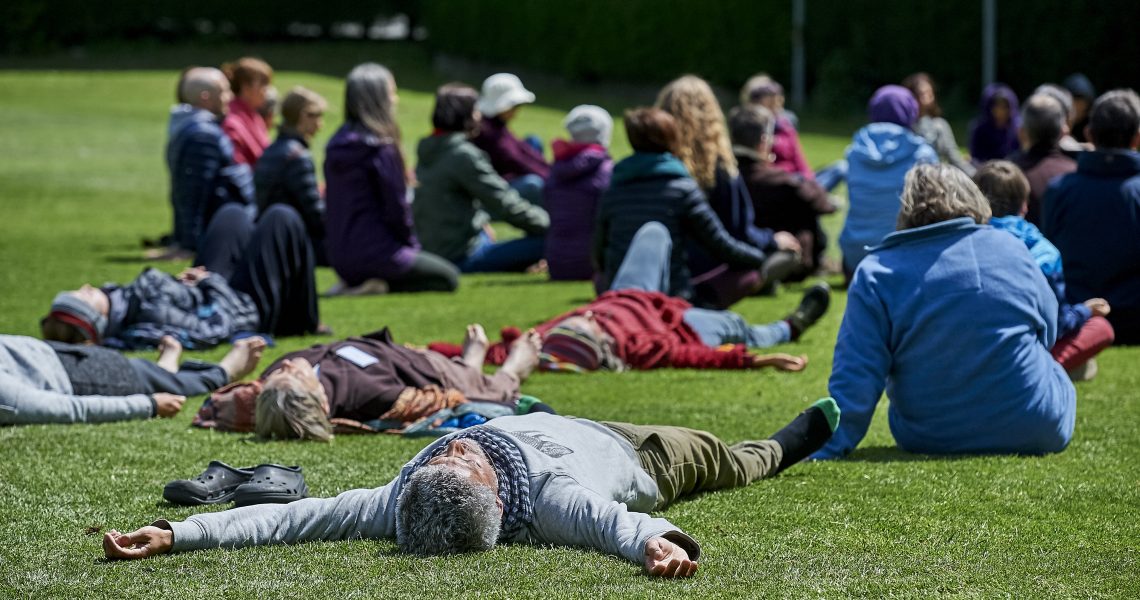 Retreat participants laying on grass