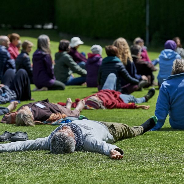 Retreat participants laying on grass