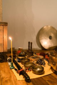 A display of cultural instruments with a candle