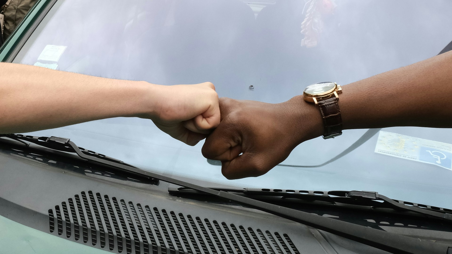 Black and white hands in a fist bump