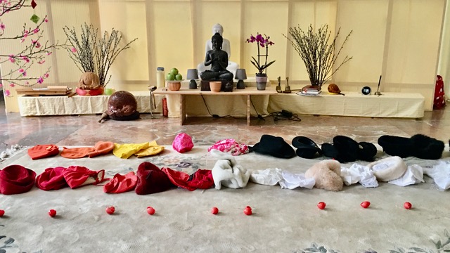 Buddhist shrine with clowning noses and hats