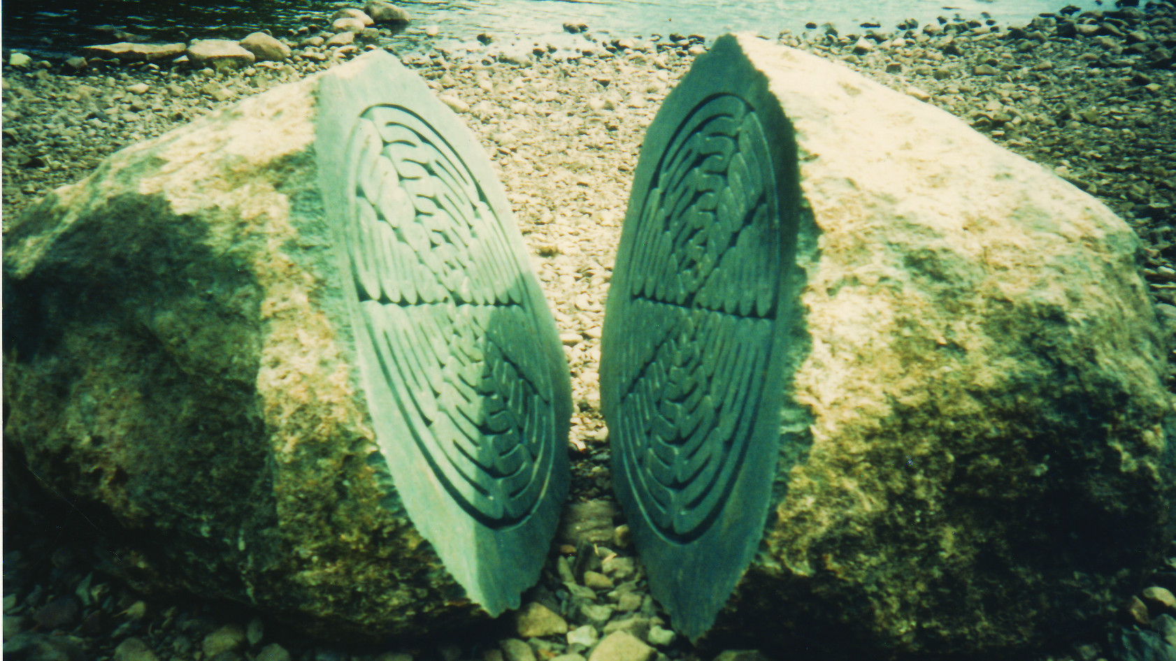 Stone on a beach split down the middle with a pattern inside