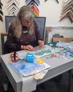 Lauri creating artwork at her desk