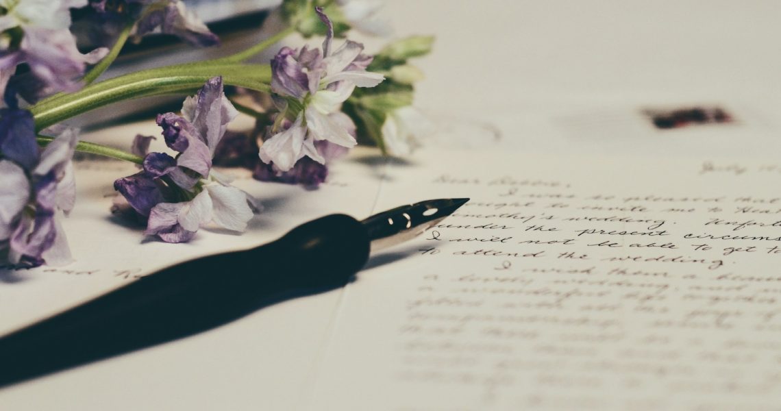 Pen, paper and purple flowers