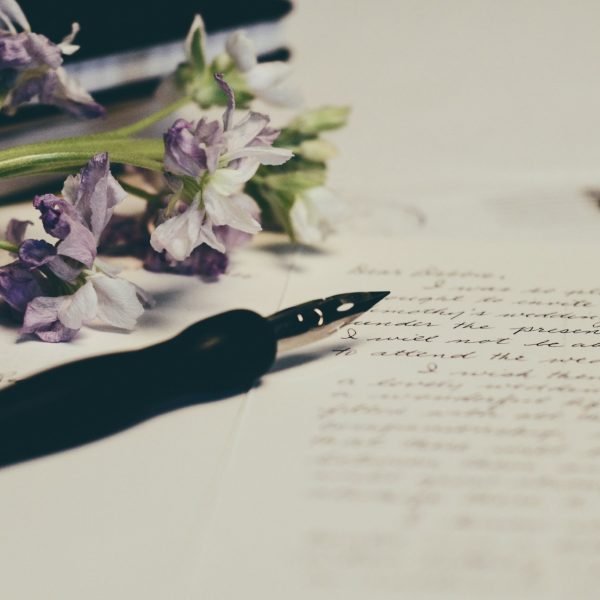 Pen, paper and purple flowers